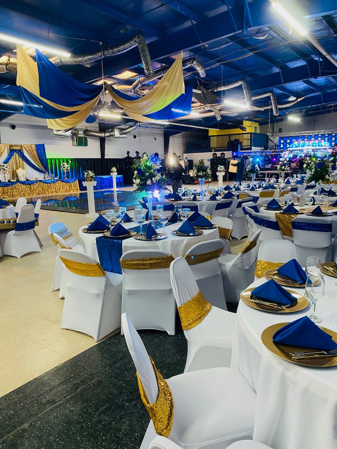 Large blue and gold reception setup in Tara Event Center's grand hall